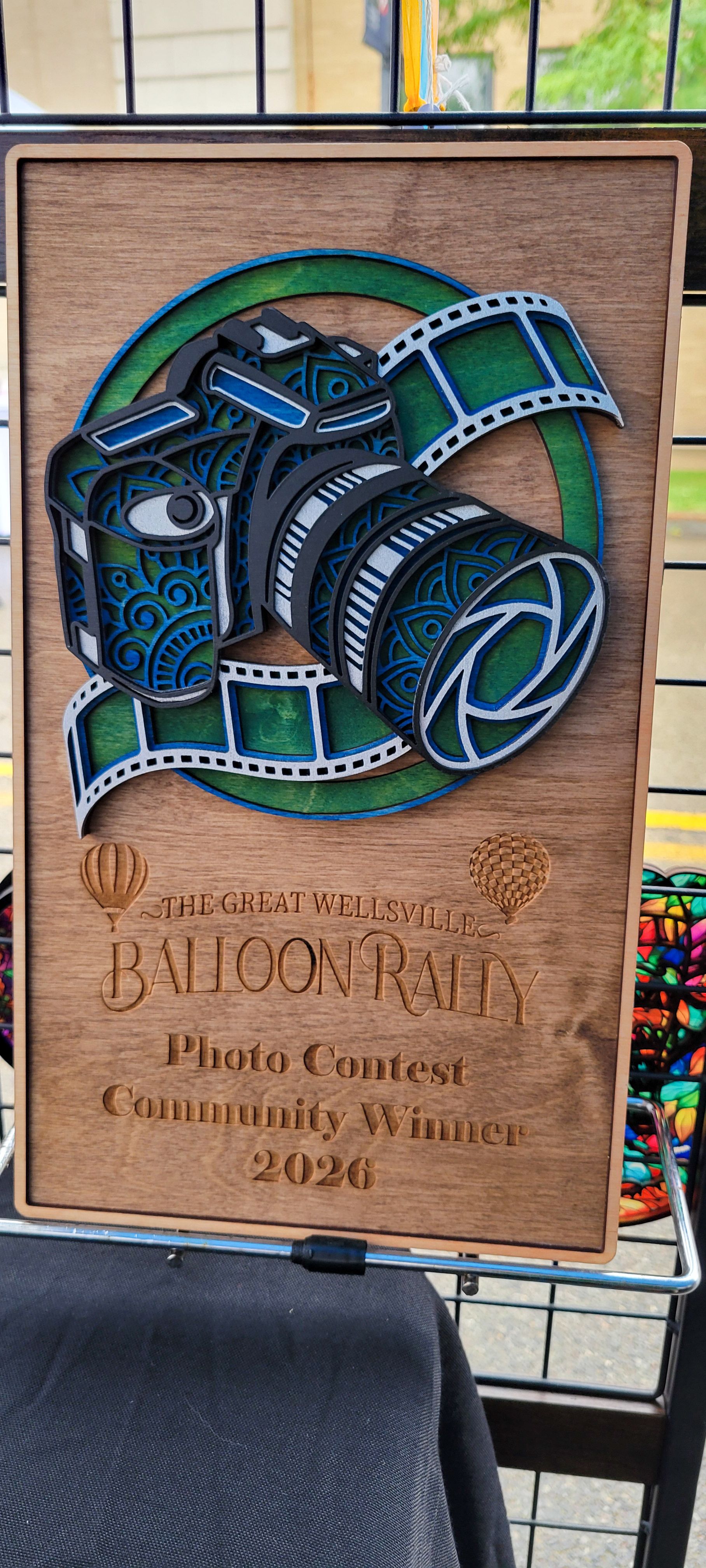 Wooden plaque award for The Great Wellsville Balloon Rally Photo Contest Community Winner 2026 with camera design.