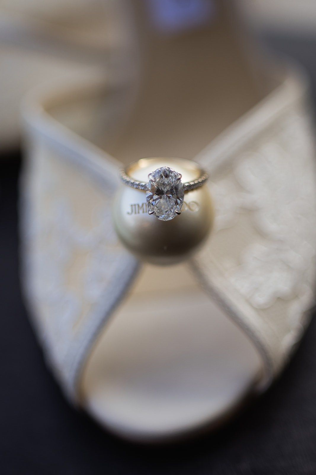 Wedding ring resting on the bride's shoe