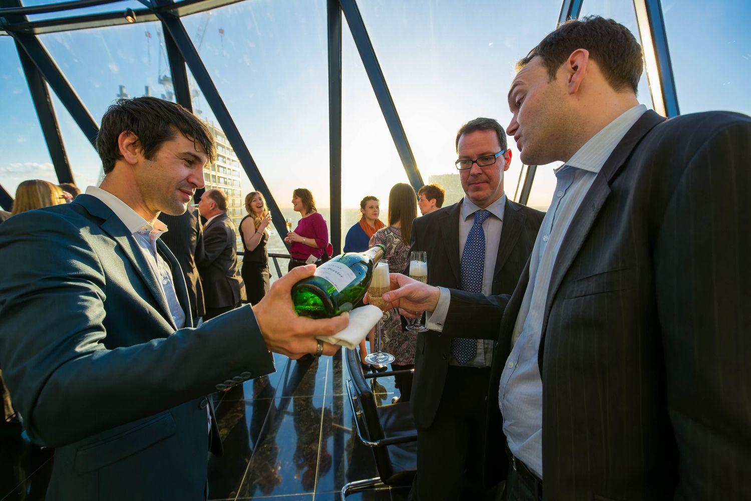 Champagne being poured for guests at a corporate evening reception at the Gherkin