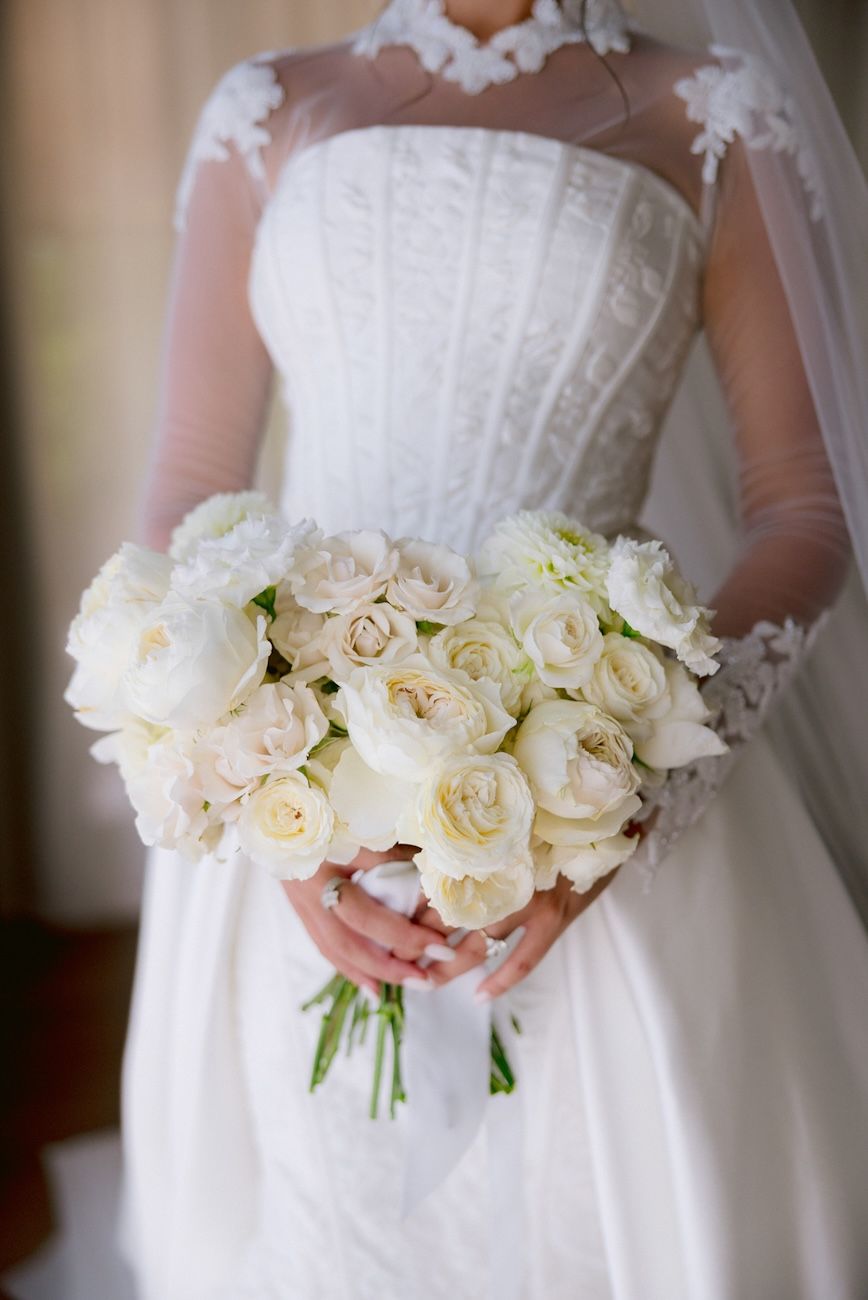 Bride and her white bridal bouquet with garden roses