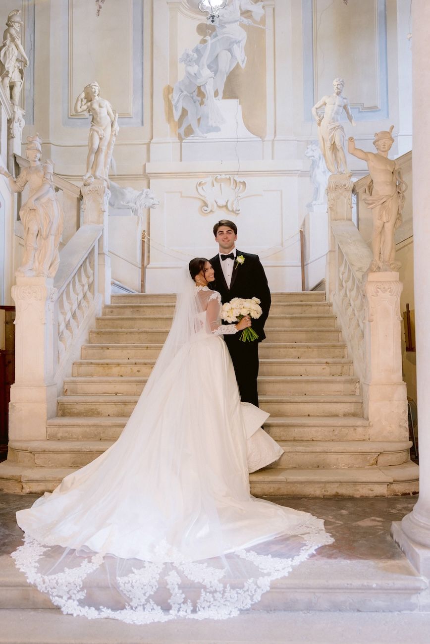 Portrait of bride and groom on the historical stairs of Villa Bettoni, Lake Garda. Italy.