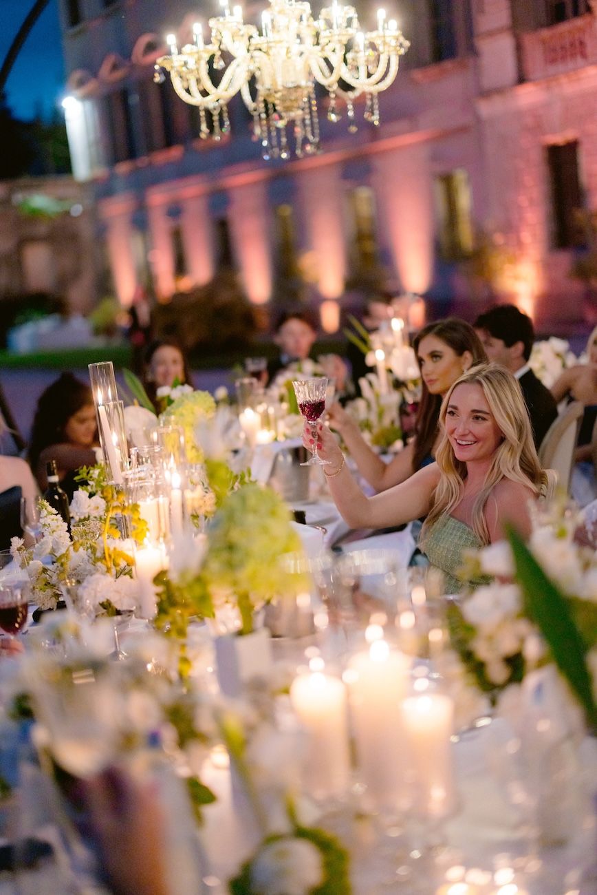 Guests celebrating during a wedding dinner at Villa Bettoni, Lake Garda, Italy. Design Solidea Events
