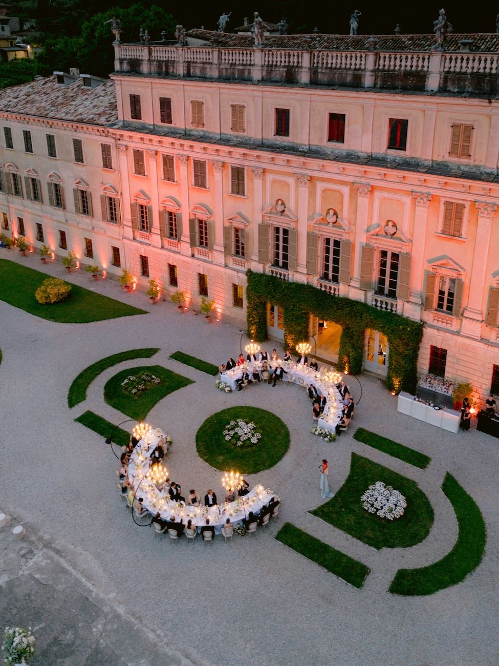 Aerial view of the semi circular tables and chandeliers used for the wedding reception at Villa Bettoni, Lake Garda. Italy. Solidea Events