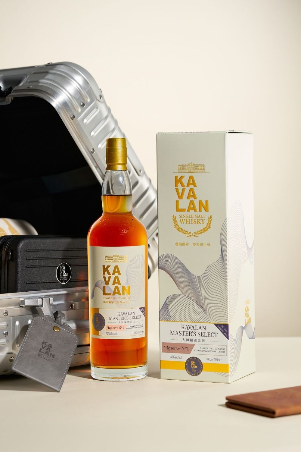 Kavalan Master's Select single malt whisky bottle beside its gift box and an open aluminum travel case.