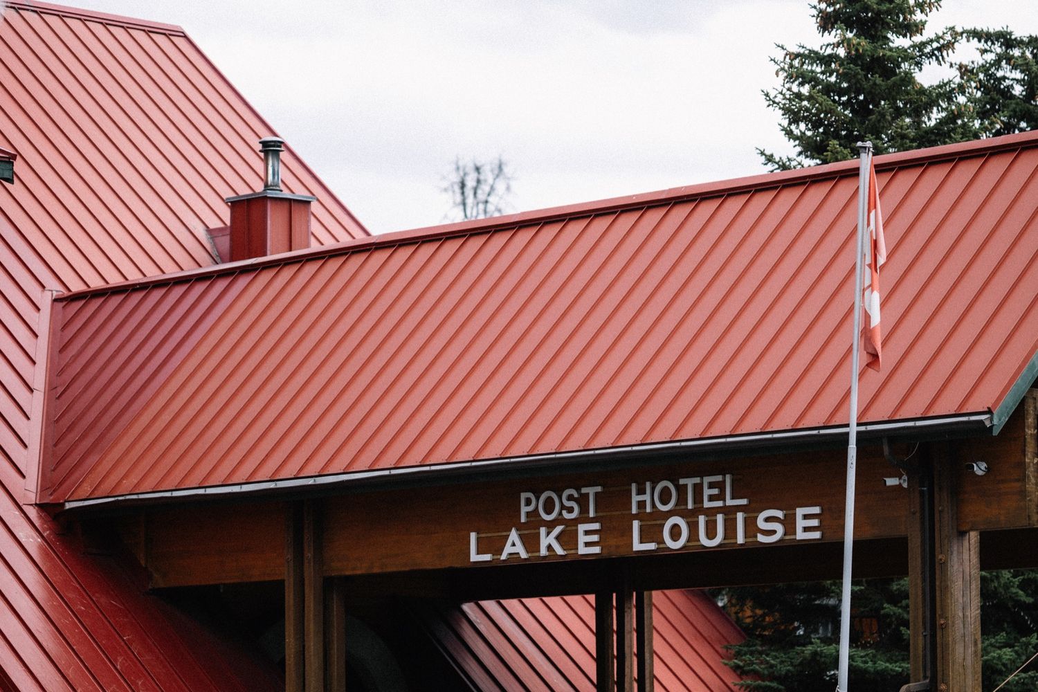 The Post Hotel Lake Louise sign and red roof on the wedding day by a Banff wedding photographer