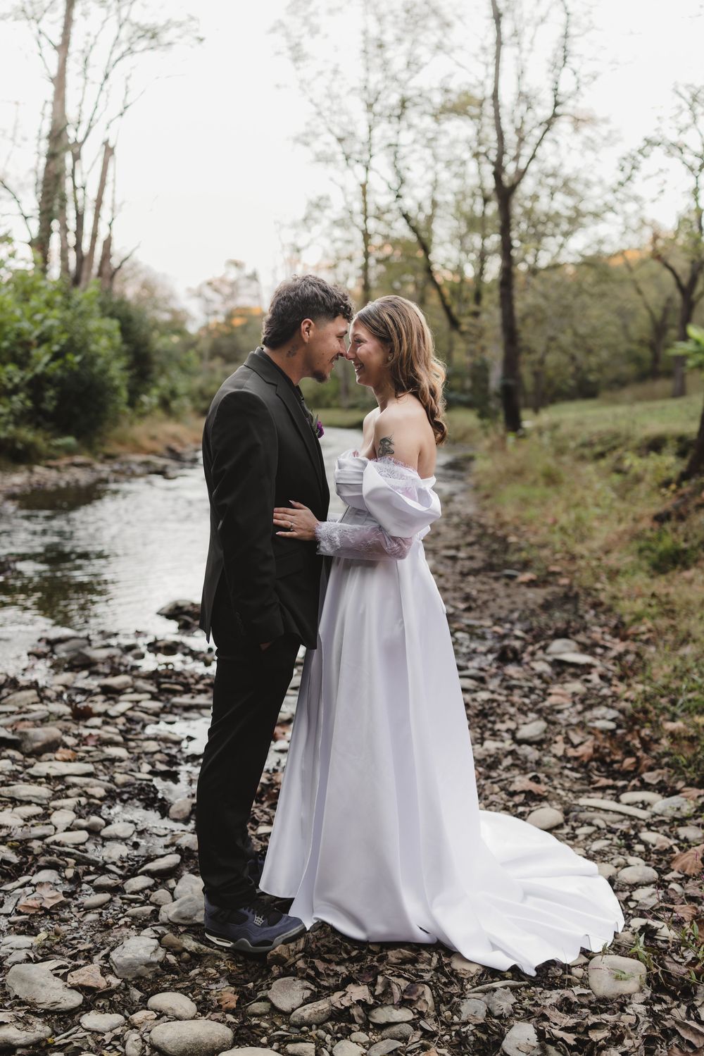 Bride and groom photographed along a scenic creek during their Smoky Mountains wedding