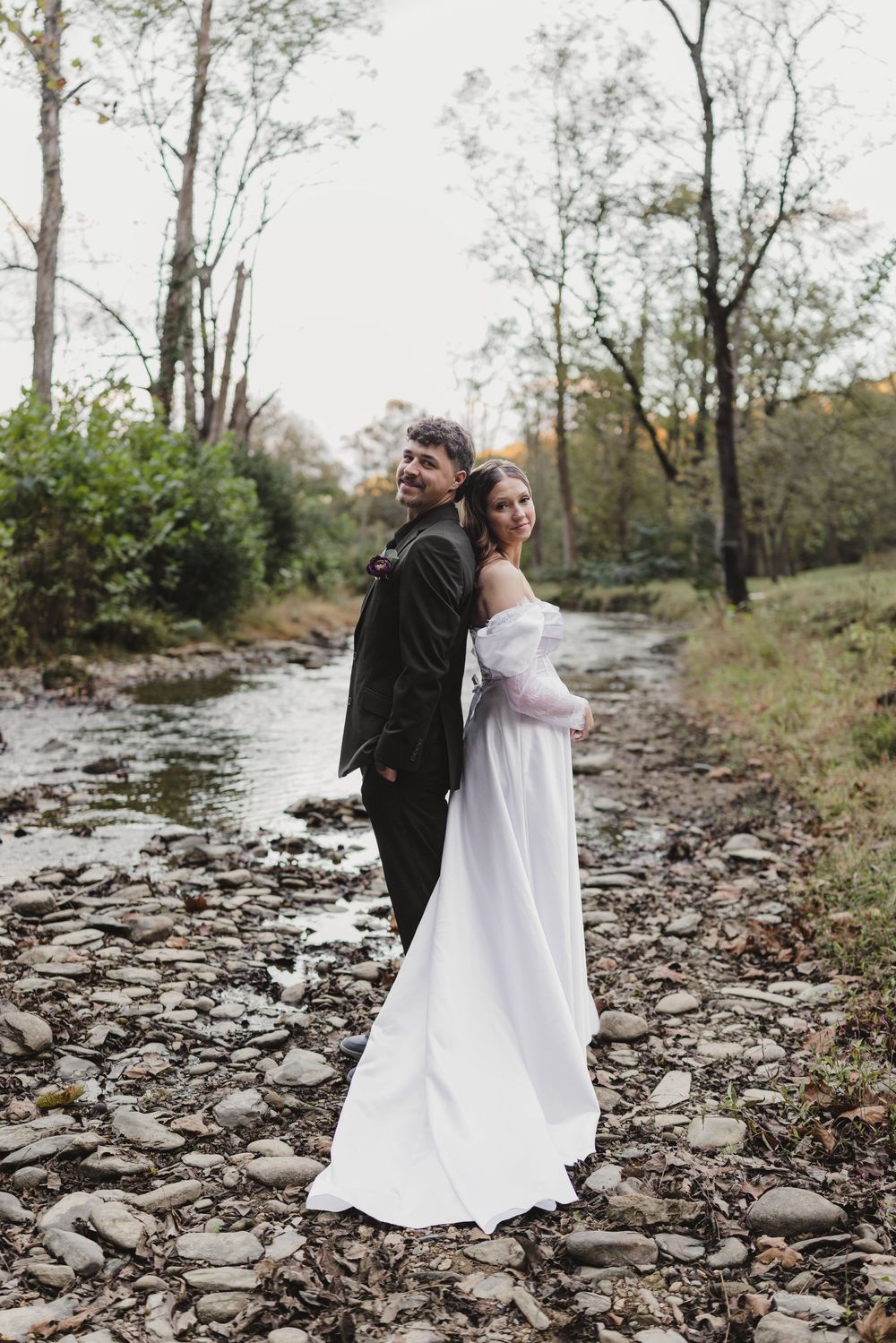 Bride and groom photographed along a scenic creek during their Smoky Mountains wedding