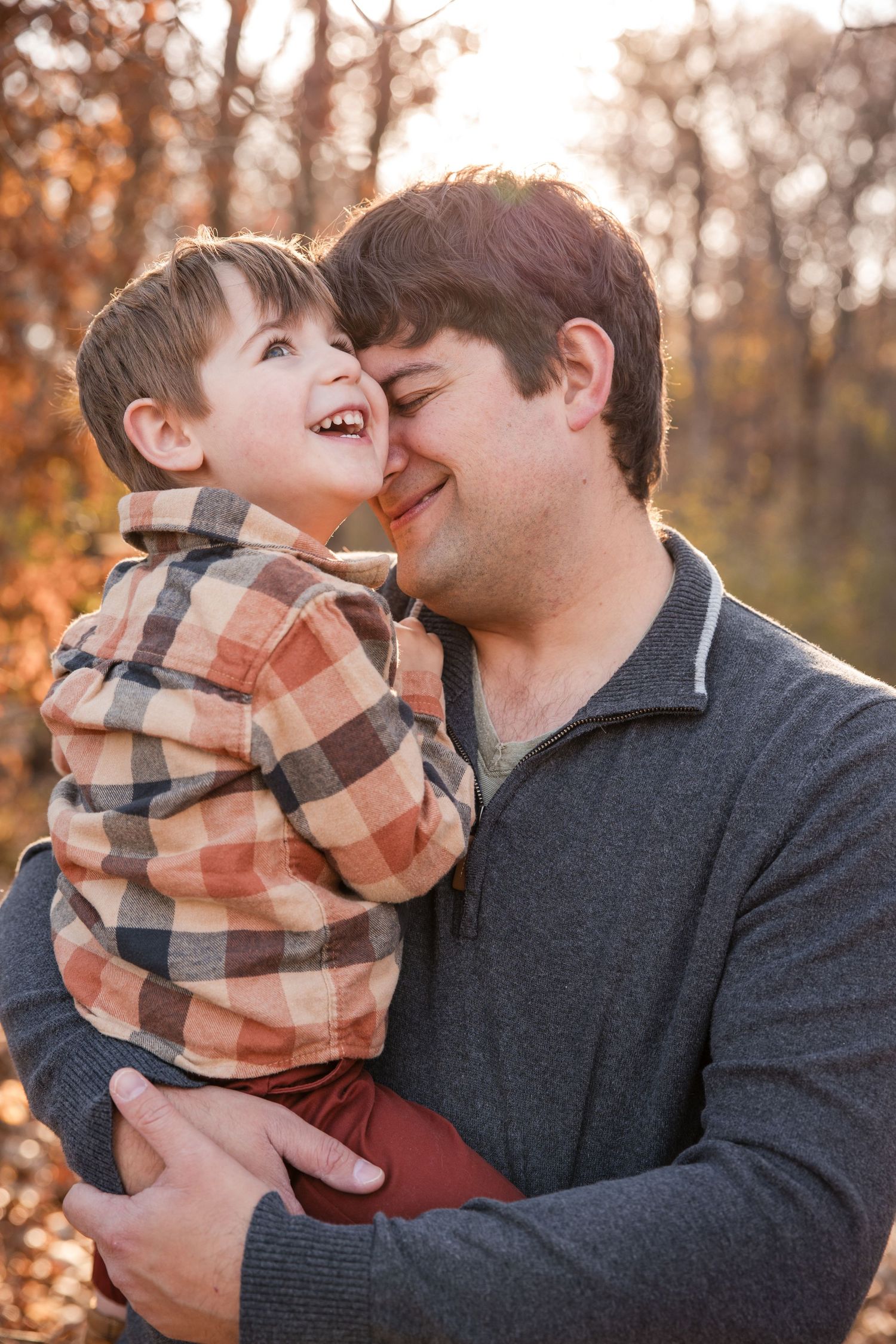 Candid autumn portrait capturing joyful moment between parent and child. Twin Cities, Decorah Iowa family photographer