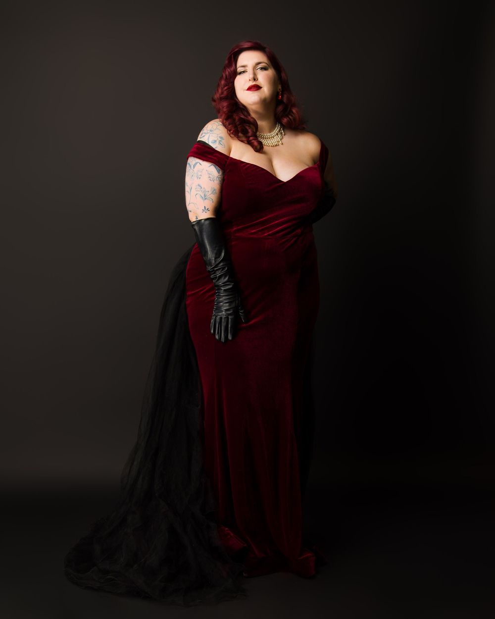 Dramatic portrait series against dark background featuring burgundy evening gown and black gloves.