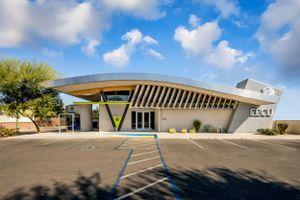 Retro-futuristic mid-century modern building with distinctive angular roof design.