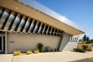 Modern architectural building exterior with distinctive angled concrete columns.