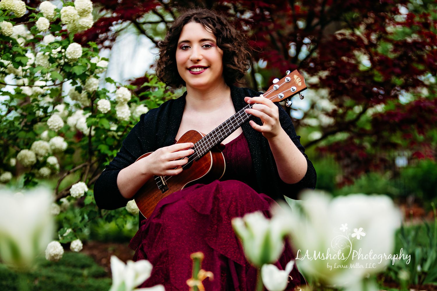 High School Senior girl sitting and playing ukulele
