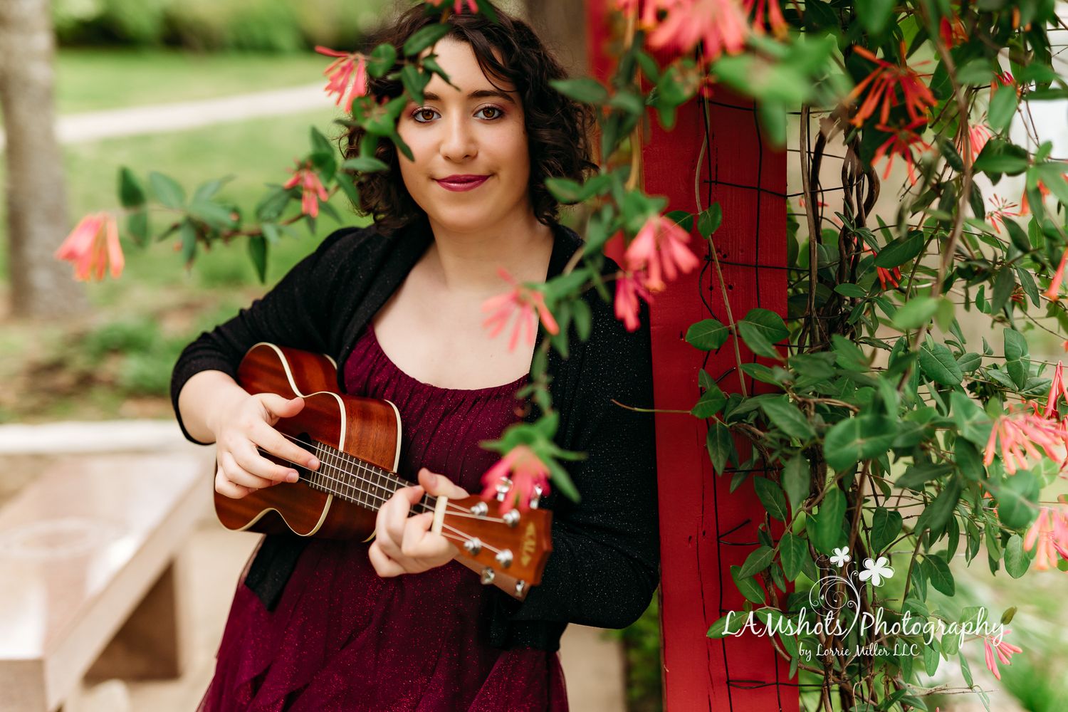 Foliage shoot through senior portrait girl playing ukulele