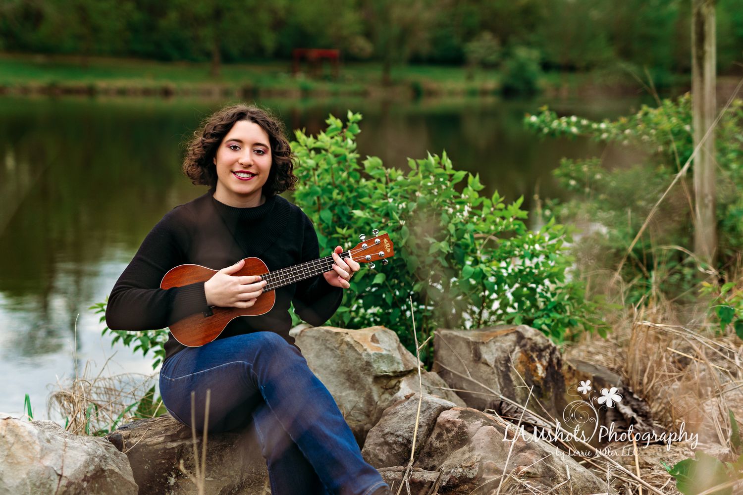 Senior girl portrait sitting on rocks with ukulele