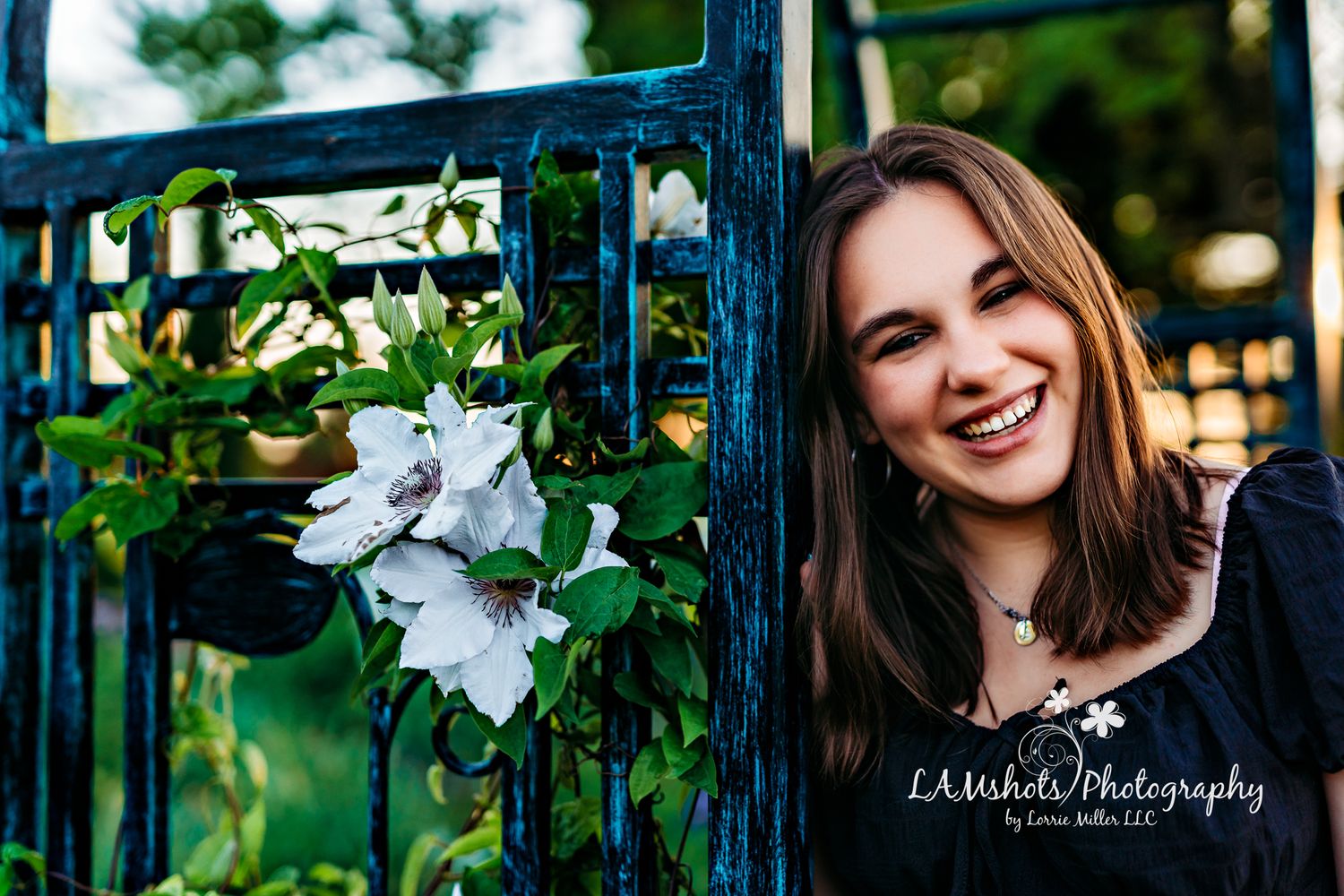 High School Senior Girl standing next to arbor