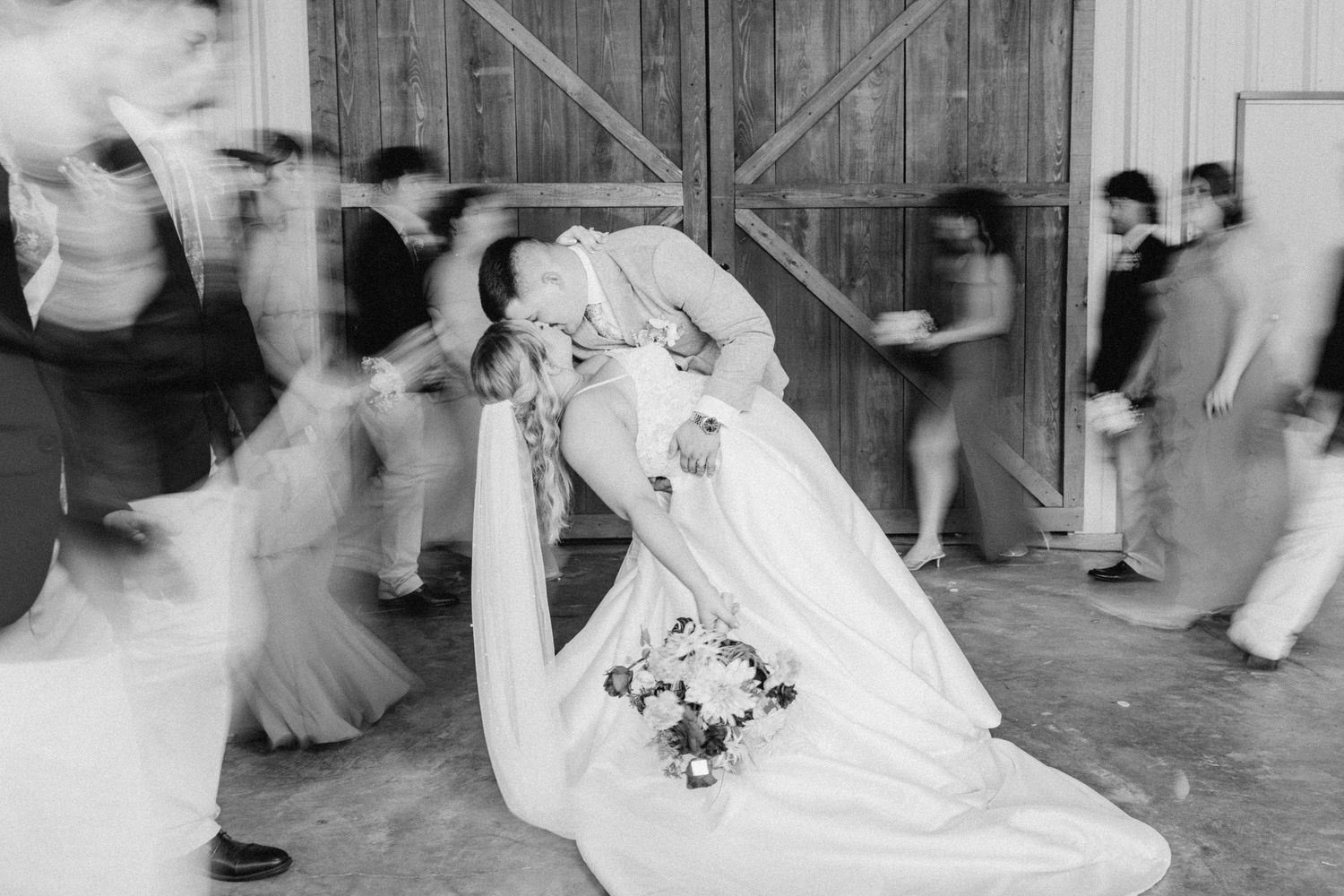An elegant wedding ceremony in a bright venue with bridesmaids in pink dresses and groomsmen in light suits.
