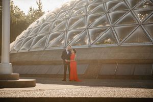 Panoramic view of a modern glass dome structure with metal framework and natural lighting.
