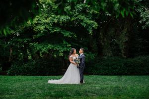 A romantic garden wedding photo with lush greenery and manicured lawns.
