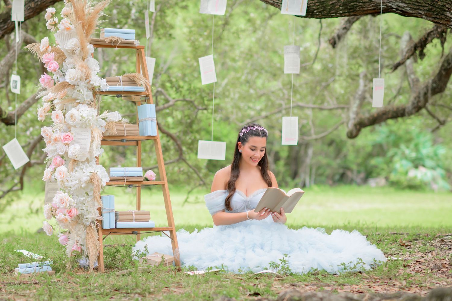 teenage girl reading a book next to a ladder bookshelf