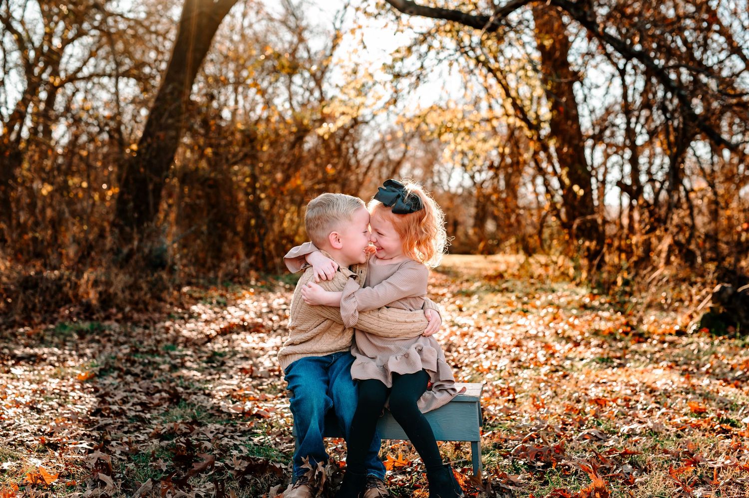 Brother and sister in a field of fall leaves at Coal Creek Farm in Jenks oklahoma but a Tulsa photographer catching fall photos