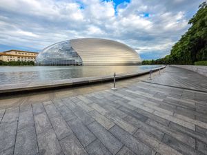 The National Centre for the Performing Arts dome reflects on water in Beijing, China.