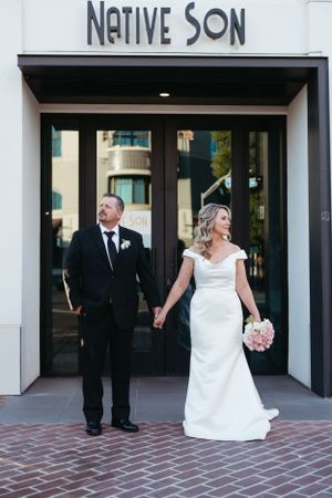 A couple exits the Native Son venue during their wedding celebration.