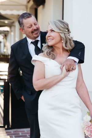 A romantic moment shared outside a venue during a wedding celebration.