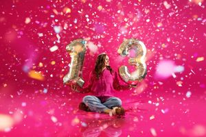 Glowing pink bokeh lights and sparkles create a magical festive background effect.