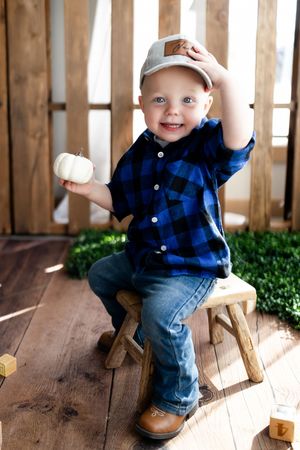 A series of photos showing a small child in blue plaid and jeans playing on wooden steps in natural lighting.