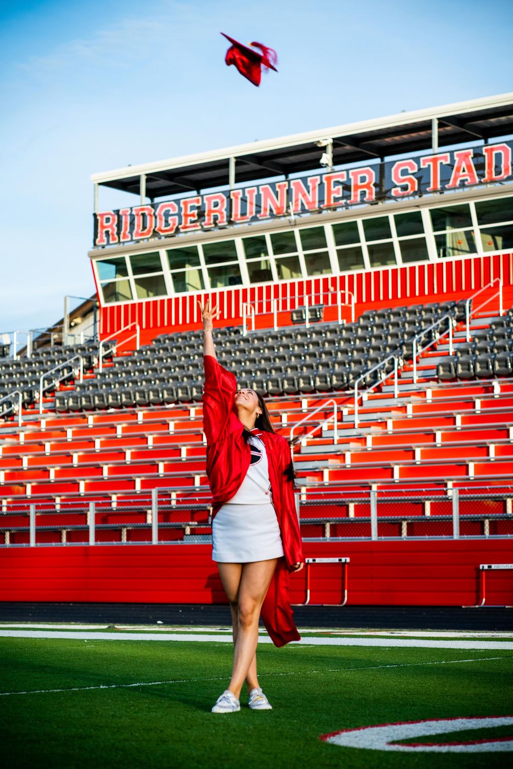 senior session, cap and gown, cheerleader, football field