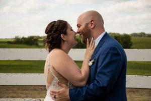 Bride and Groom by fence