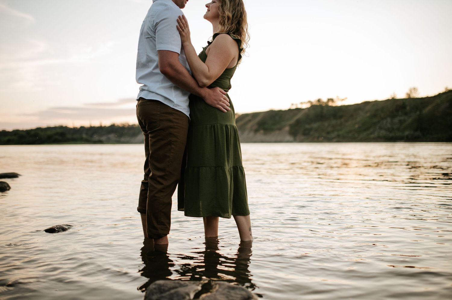 A dramatic couple's photo with vibrant orange smoke bombs creating an atmospheric backdrop.