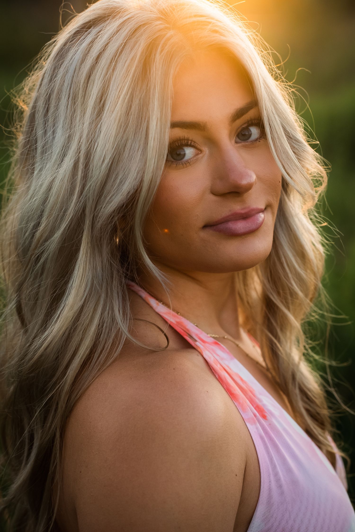 Backlit portrait series with soft golden sunlight creating a dreamy atmosphere against a natural outdoor backdrop.