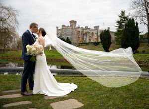 Romantic wedding photography at Bellingham castle , Louth, featuring a couple with a flowing veil by AK Wedding Photography & Videography.