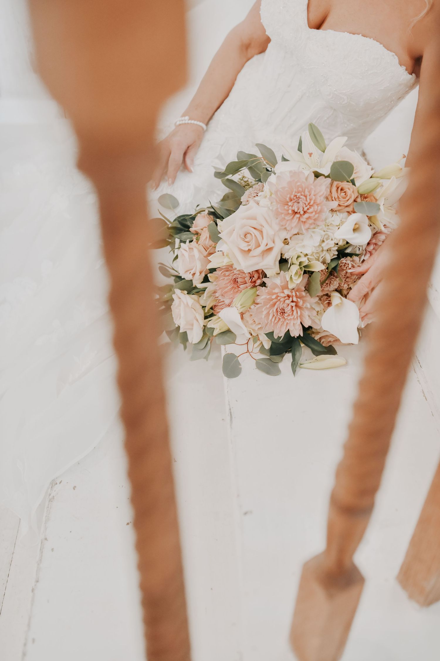 Bride posing for portraits on the staircase before her wedding ceremony