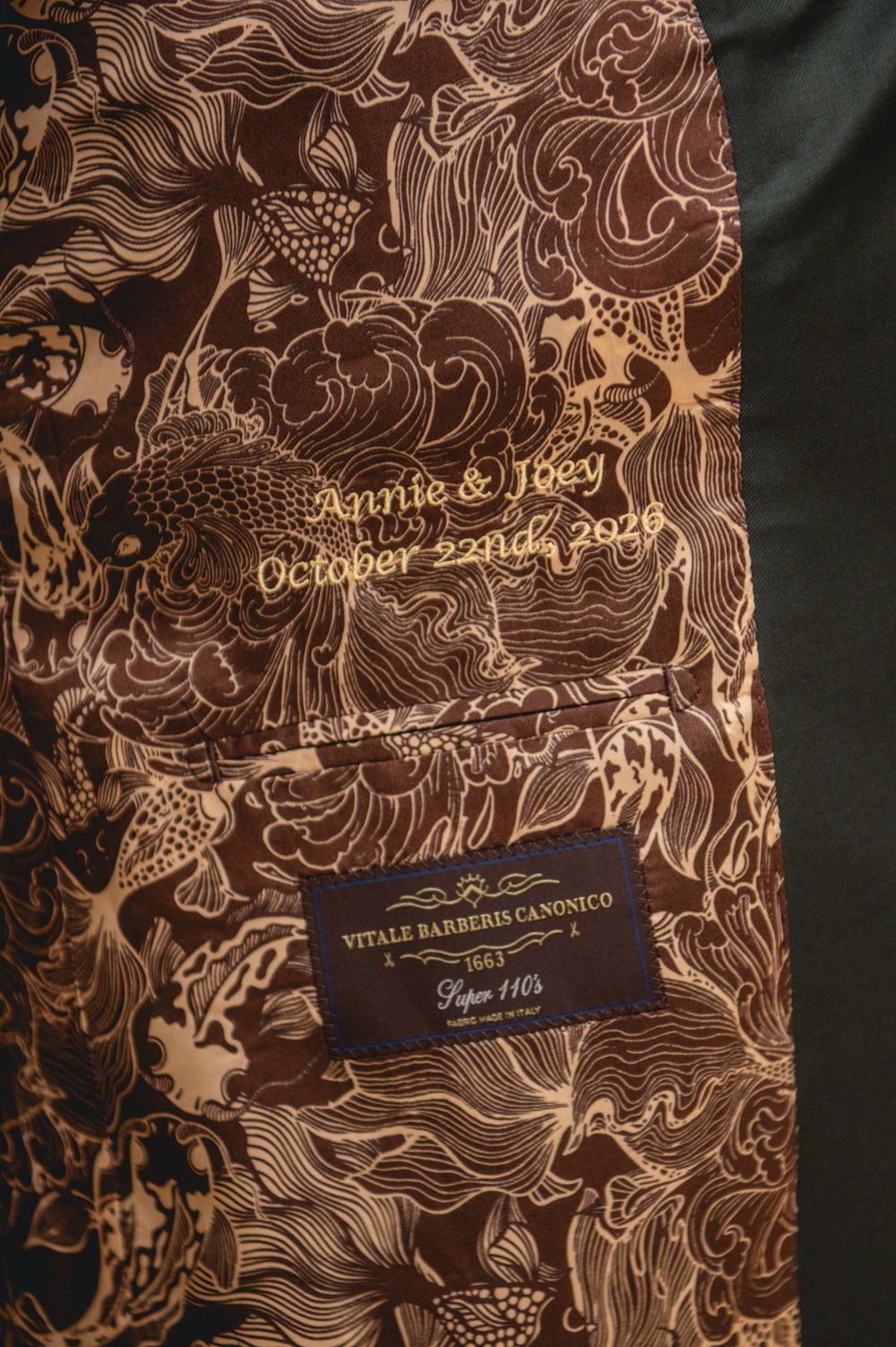 Custom suit jacket lining with ornate brown koi pattern, embroidered Annie & Joey October 22nd, 2026, and a Vitale Barberis Canonico label.