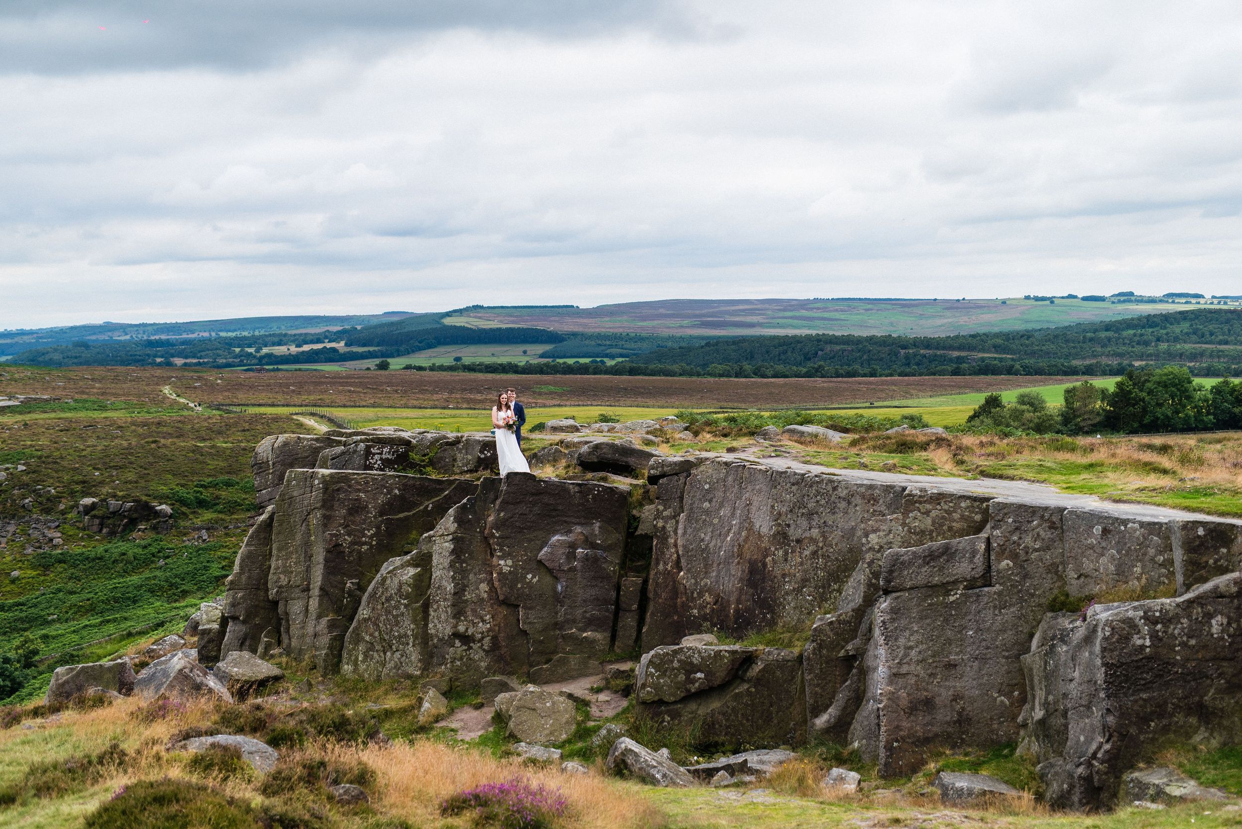 Tegan and James on the rocky Curbar Edge in the Peak District after their wedding