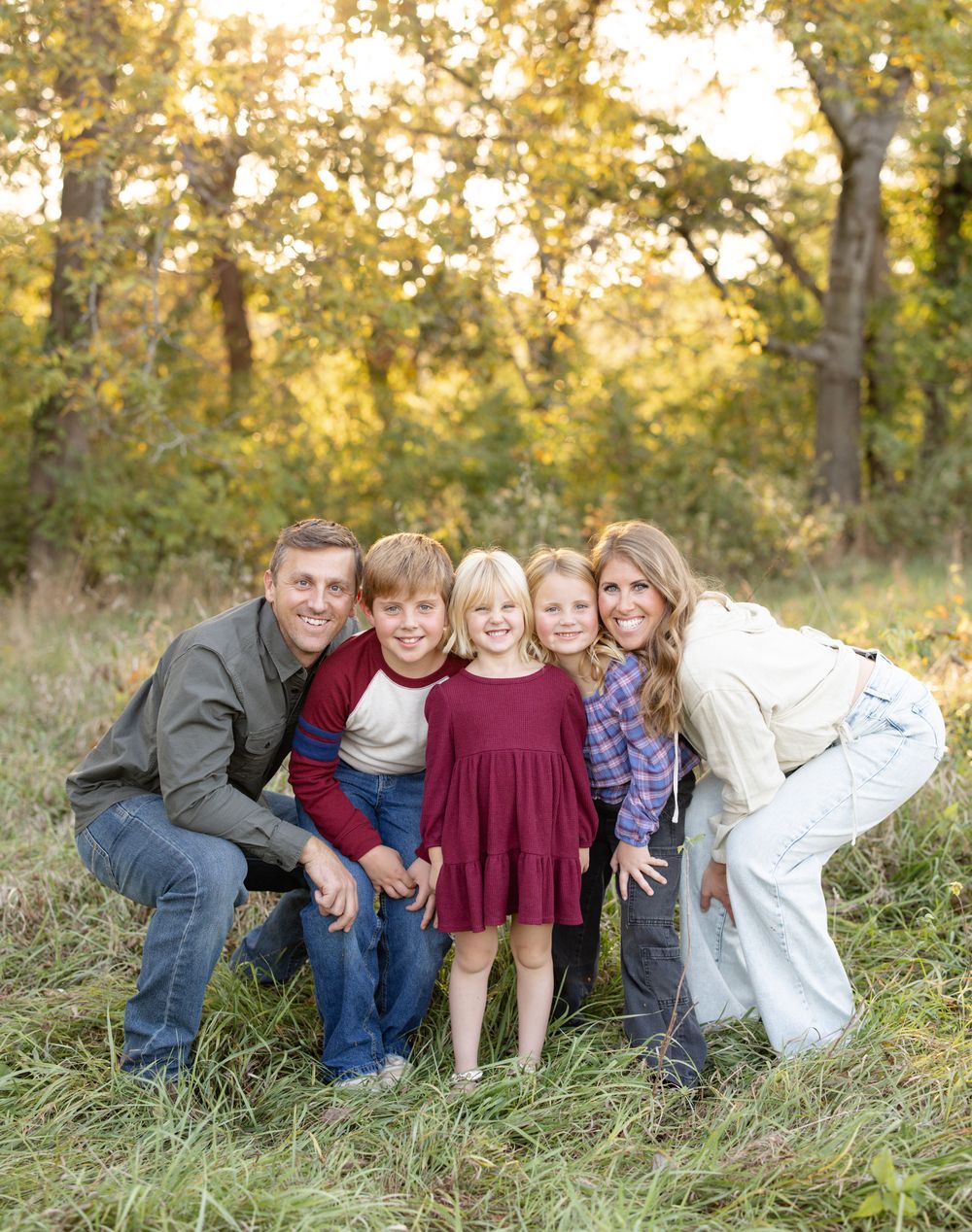 Parents and children smiling together during an outdoor family photo session