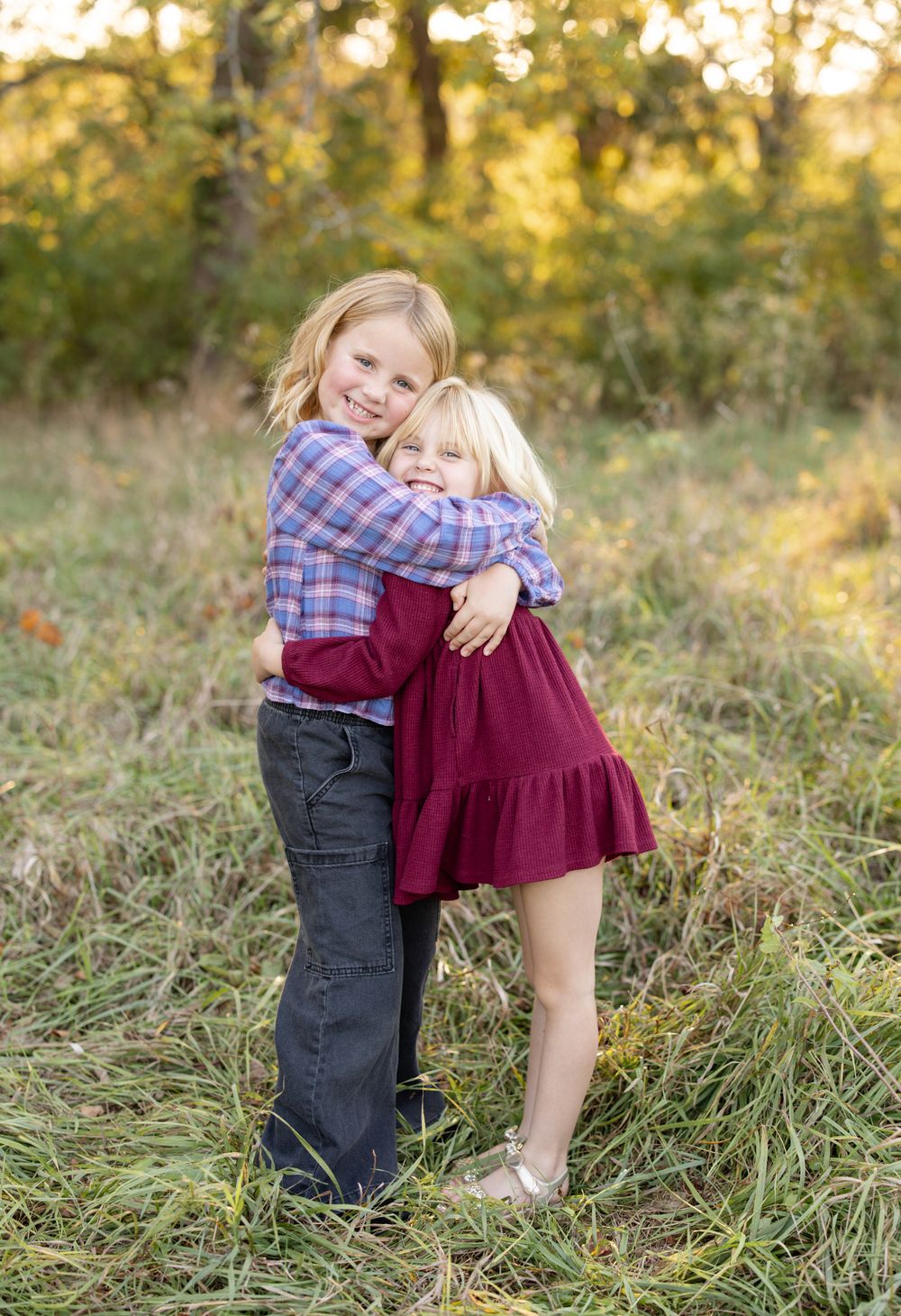 Siblings smiling together during an outdoor family photography session in st. louis