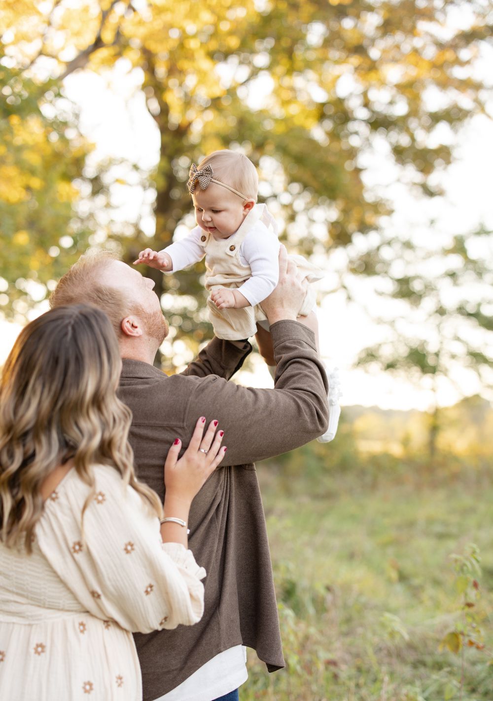 Family of three photographed outdoors at Broemmelsiek Park in Defiance, Missouri