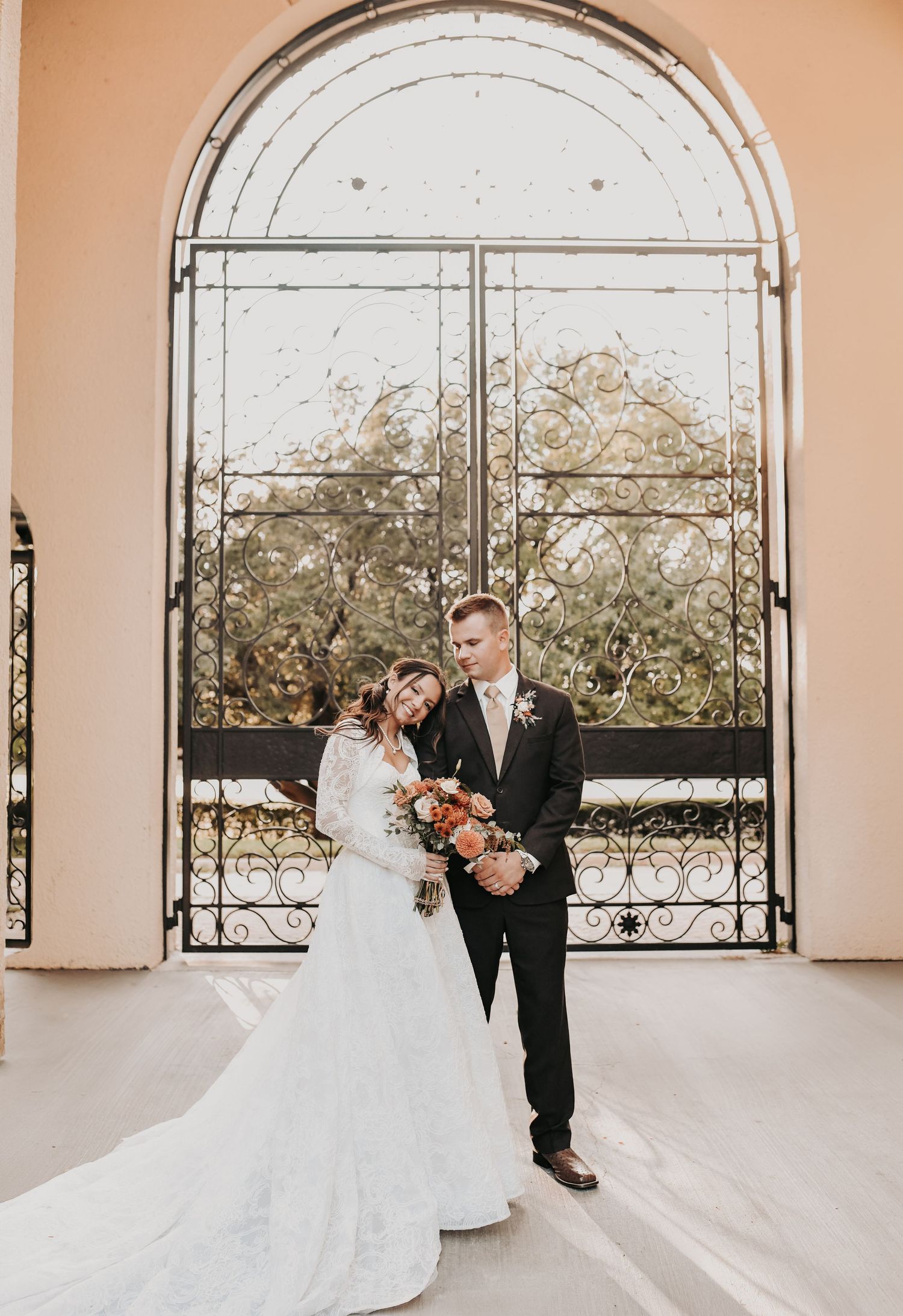 Newly married couple walking through St Ann Catholic Parish courtyard