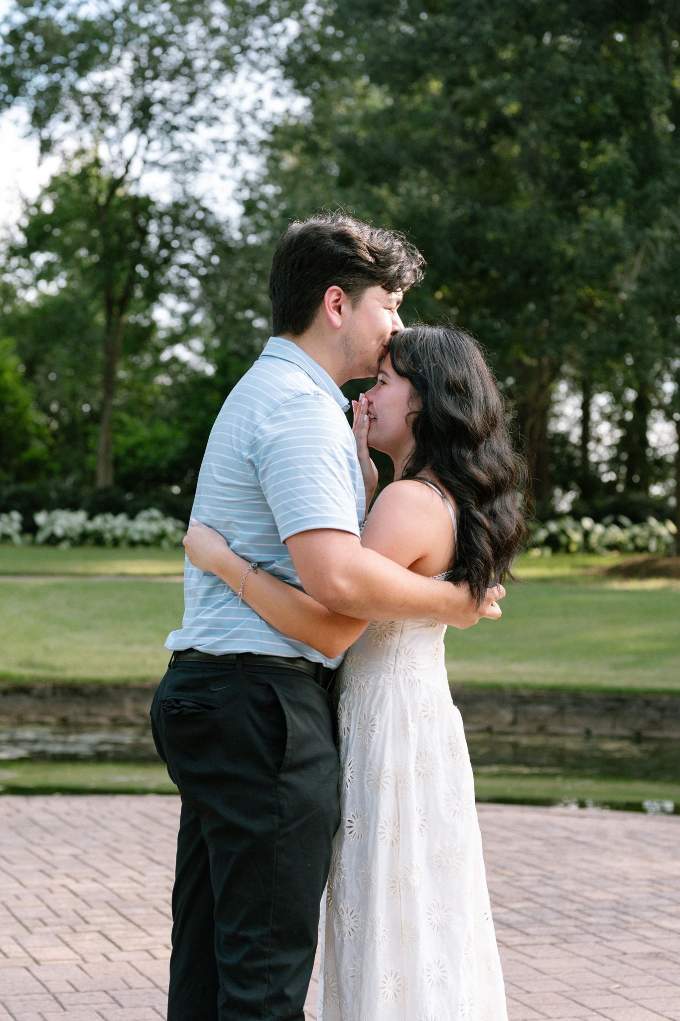 A couple shares a romantic moment during proposal at Mercer Botanic Garden in Spring Tx