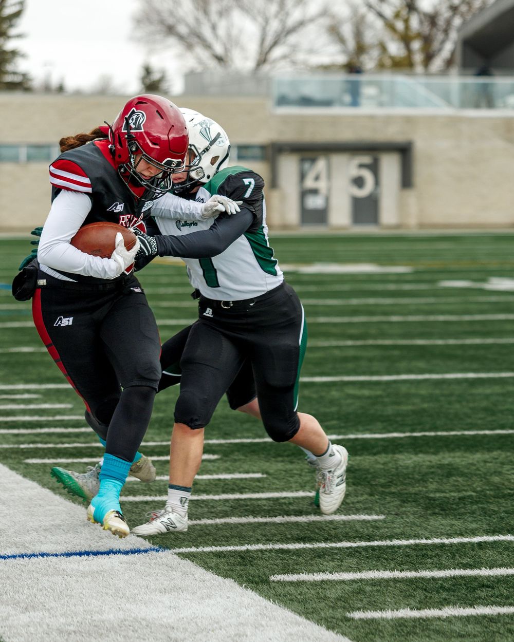 Regina Riot player breaks a tackle attempt during a women's football game.