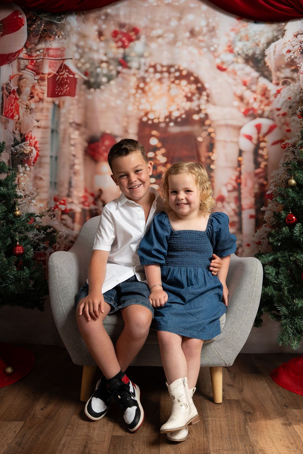 brother and sister in a christmas photo setting