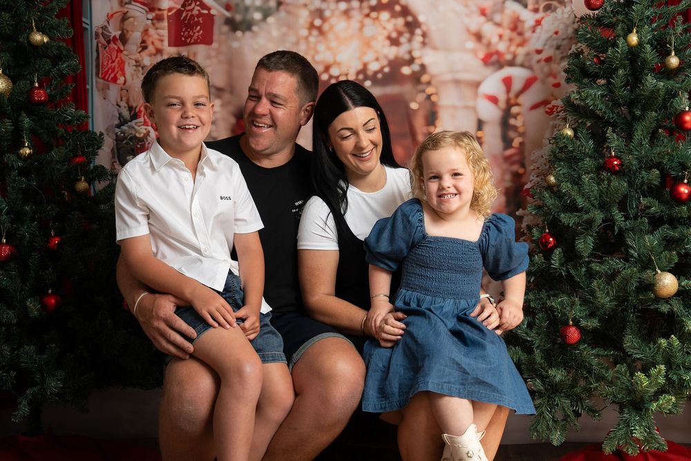 family on a christmas backdrop