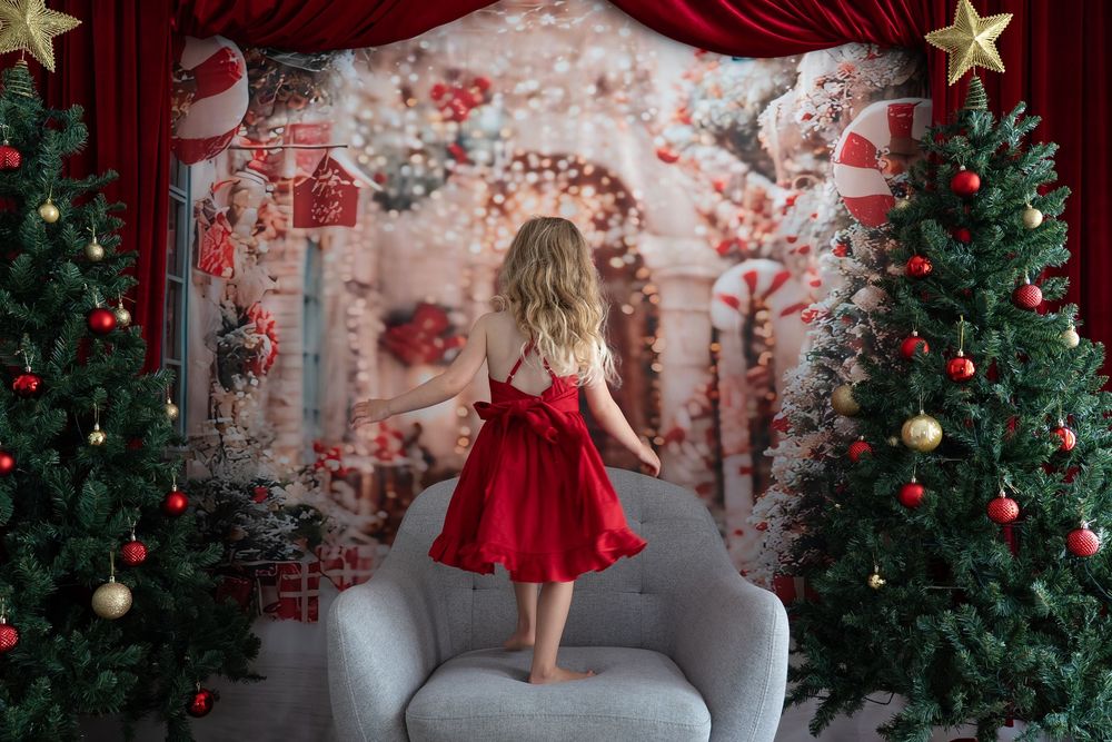 girls dancing on chair on a christmas backdrop