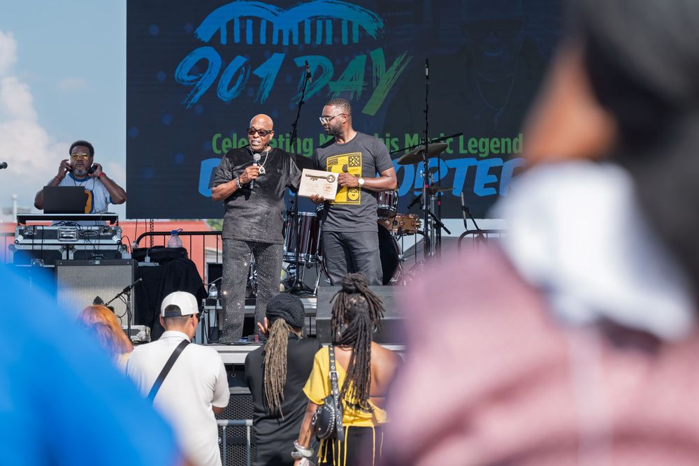 Two speakers on stage at 901 Day outdoor music festival event celebrating Memphis music legends.