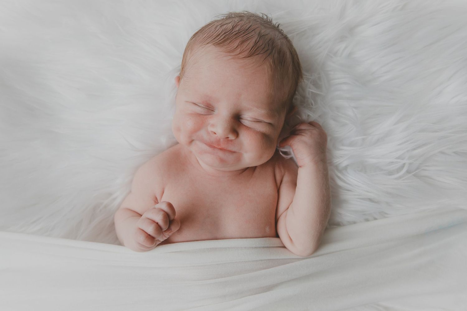 Adorable newborn baby boy - smiling! Newborn family session. North Wales