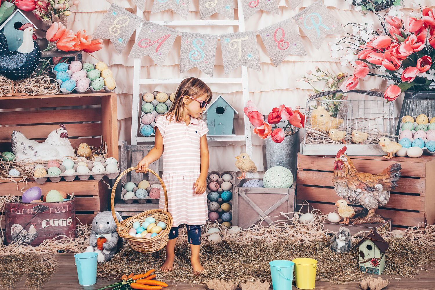 Young girl holding an Easter basket in a pastel seasonal studio setup