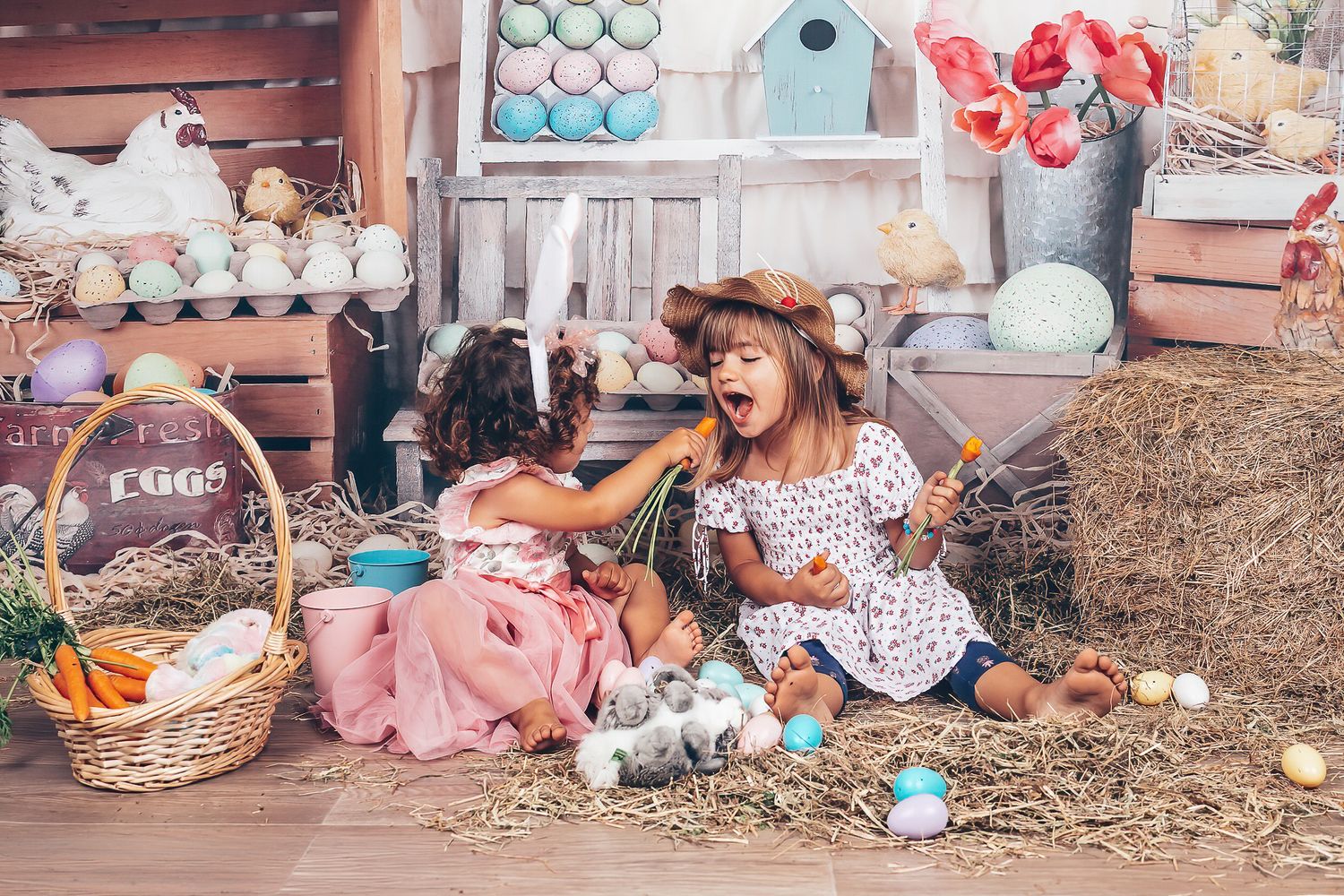 Two girls sharing a playful moment with carrots during a colourful Easter studio session